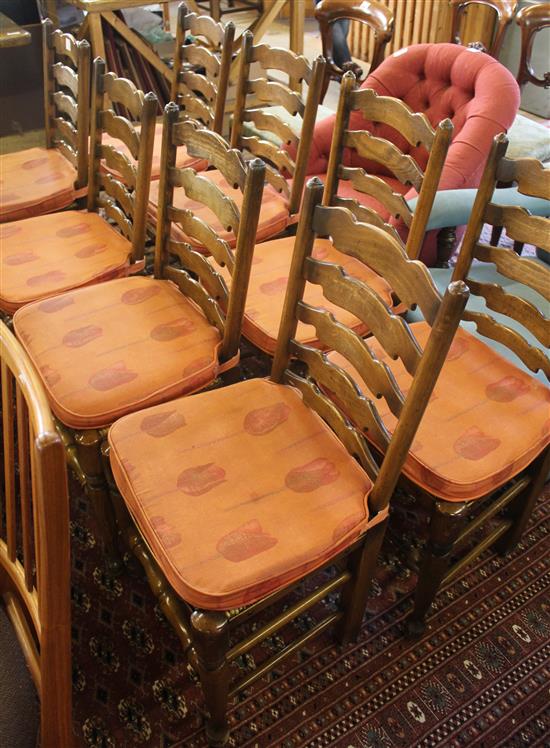 Eight oak rush seated ladderback dining chairs